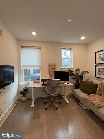 a living room with furniture window and a flat screen tv