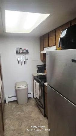 a kitchen with a refrigerator and a sink