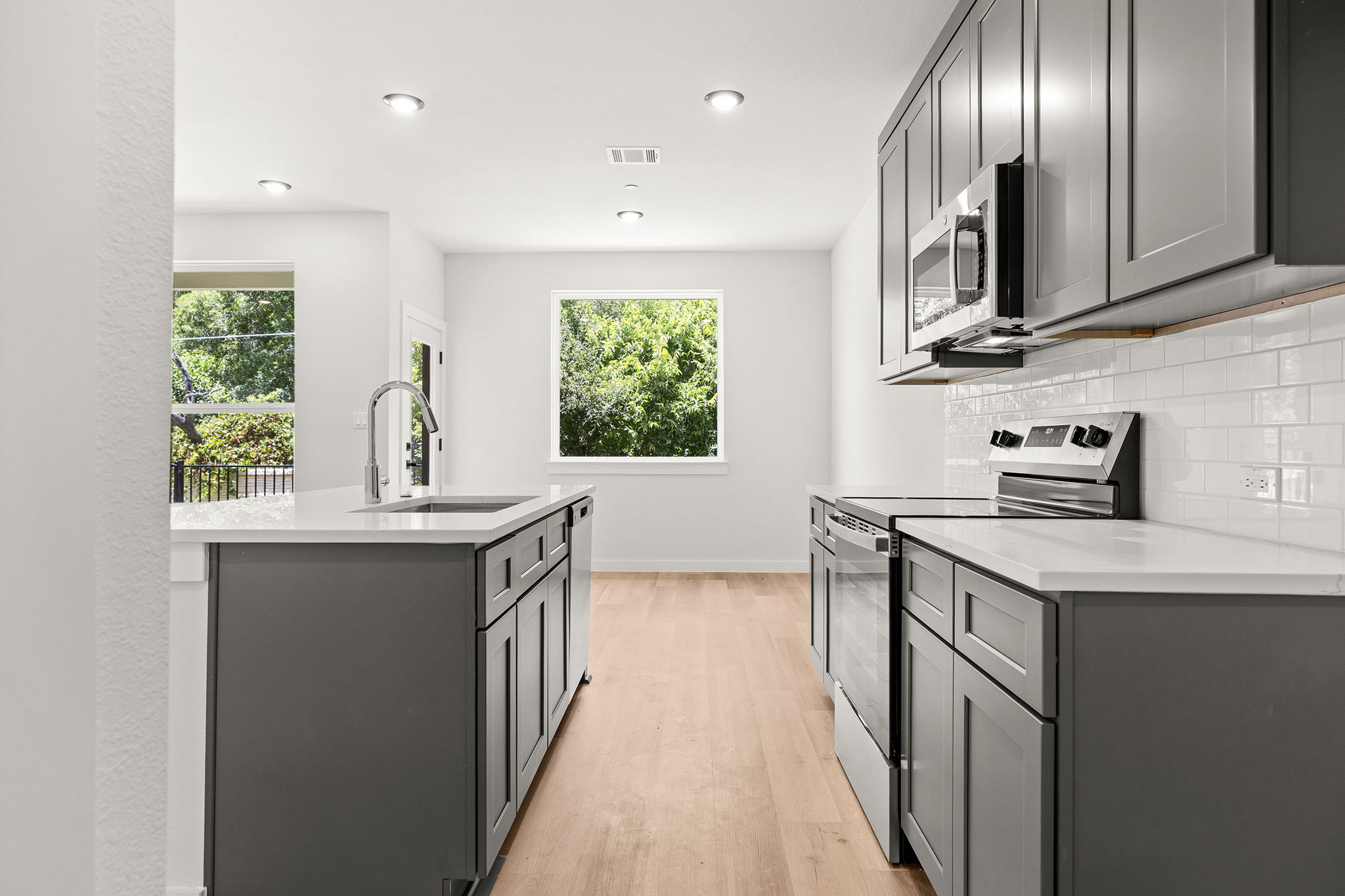2600 Gattis School Road, Unit 1002 Round Rock, TX 78664 - Photo 2 of 40 Modern kitchen with sleek cabinetry, an inviting island, and naturally illuminated by an exterior view.