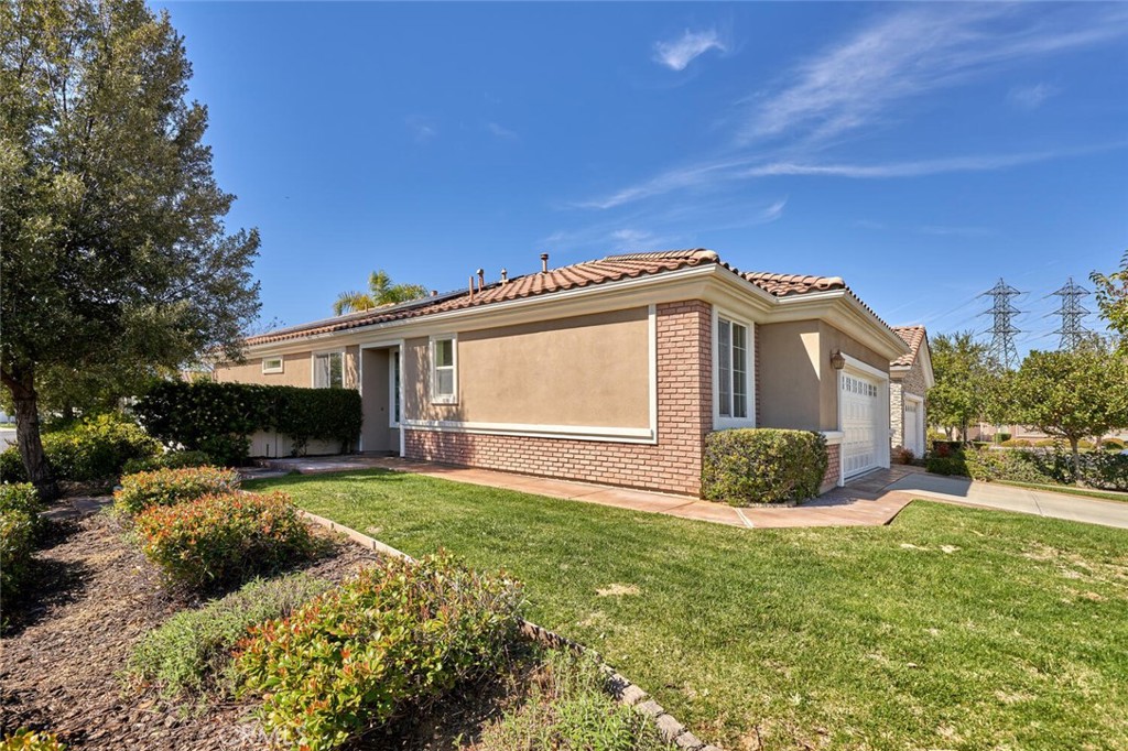 1143 Saguara Road Beaumont, CA 92223 - Photo 12 of 66 a front view of a house with a garden and yard