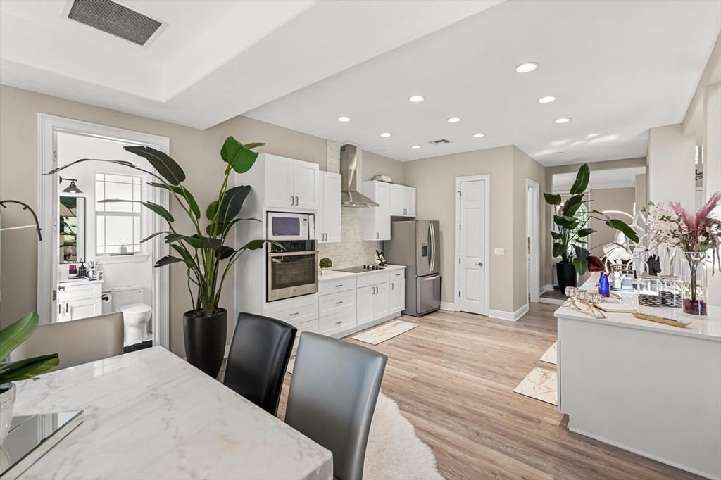 10370 Trout Road Orlando, FL 32836 - Photo 13 of 41 a living room with kitchen island furniture and a potted plant