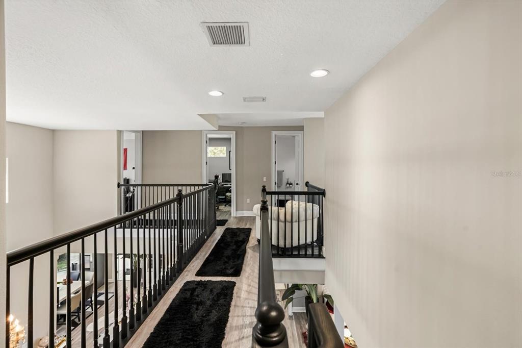 10370 Trout Road Orlando, FL 32836 - Photo 17 of 41 a view of a hallway with wooden floor and staircase