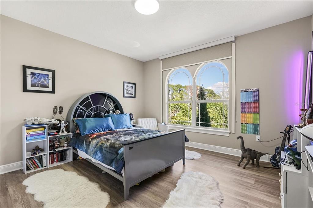 10370 Trout Road Orlando, FL 32836 - Photo 18 of 41 a bedroom with a bed a table and a large window