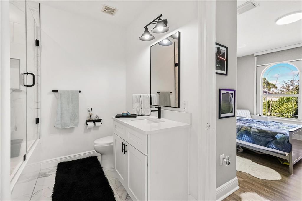 10370 Trout Road Orlando, FL 32836 - Photo 21 of 41 a bathroom with a sink a toilet a mirror and shower