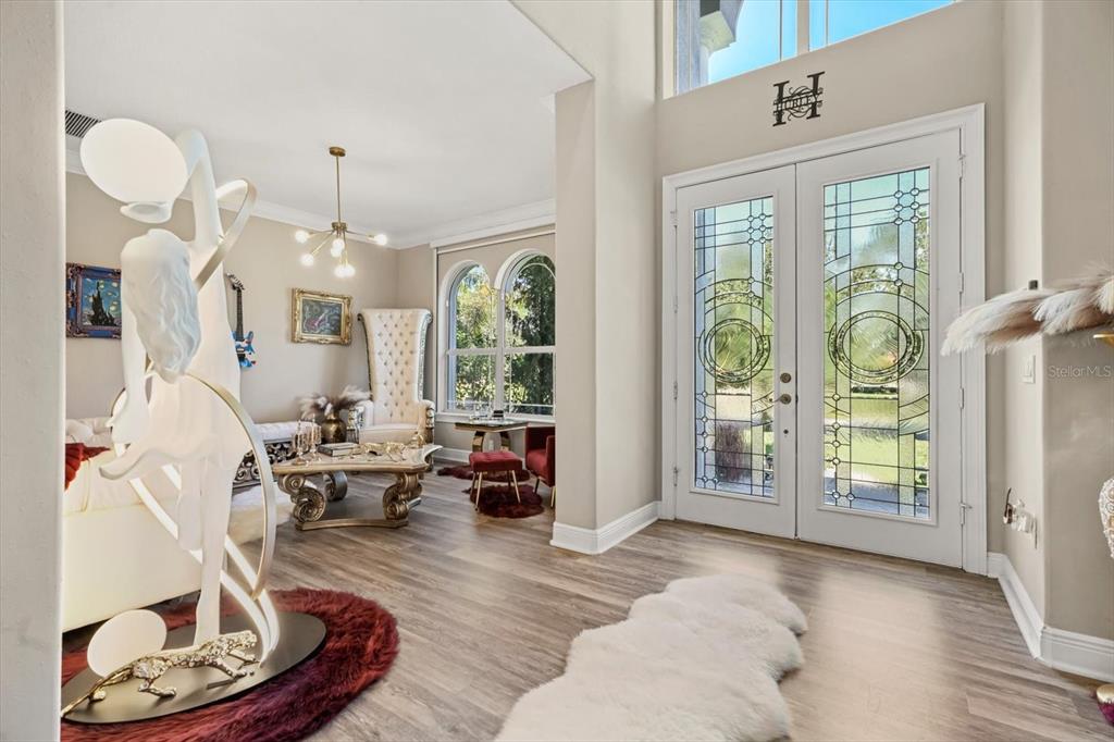 10370 Trout Road Orlando, FL 32836 - Photo 5 of 41 a living room with furniture chandelier and a fireplace