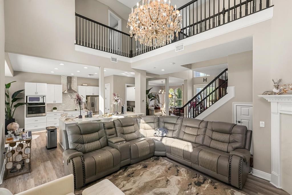 10370 Trout Road Orlando, FL 32836 - Photo 10 of 41 a living room with furniture or wooden floor and a chandelier