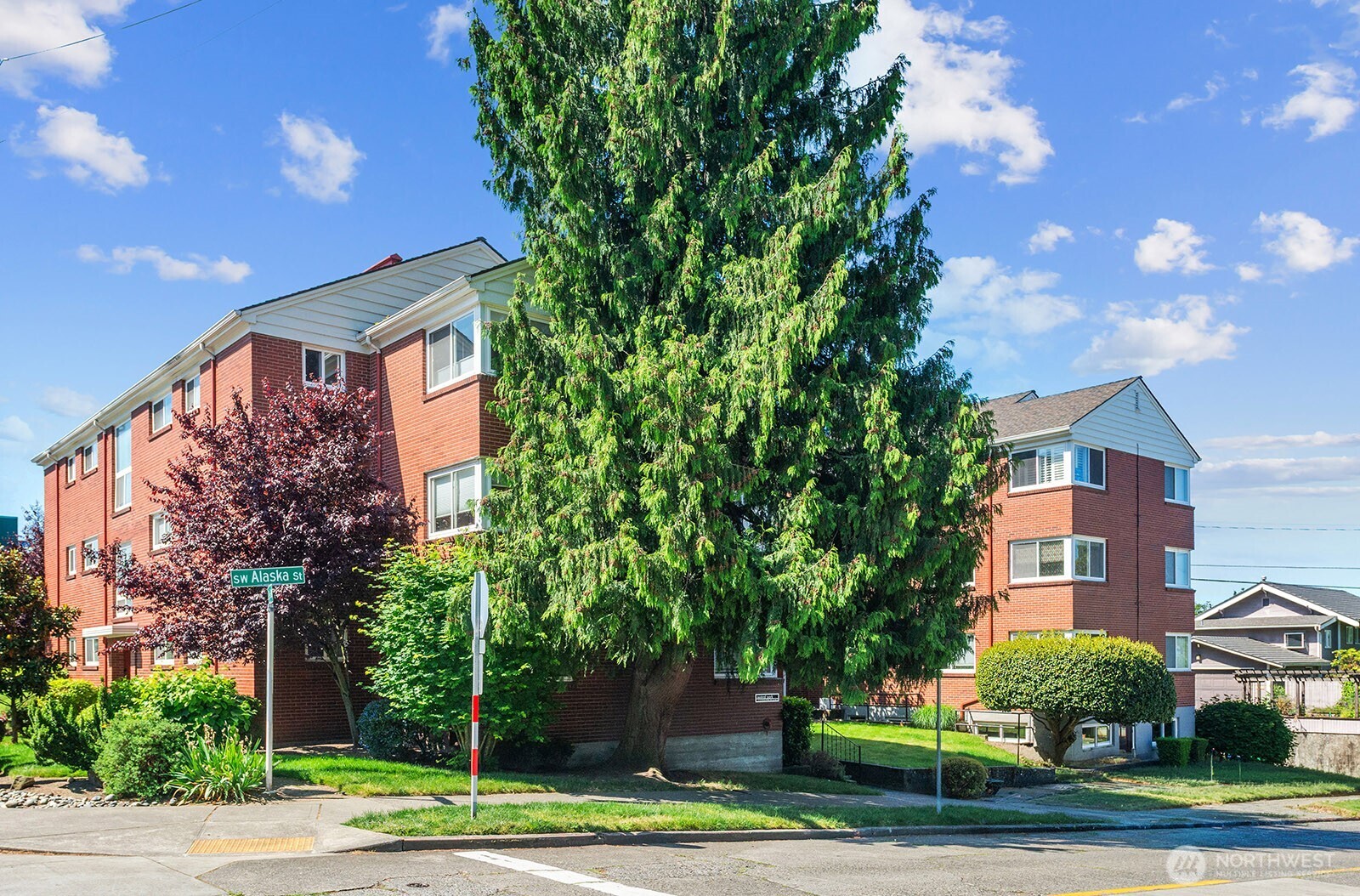 4407 Southwest Alaska Street, Unit 11 Seattle, WA 98116 - Photo 1 of 24 a front view of a house with a yard