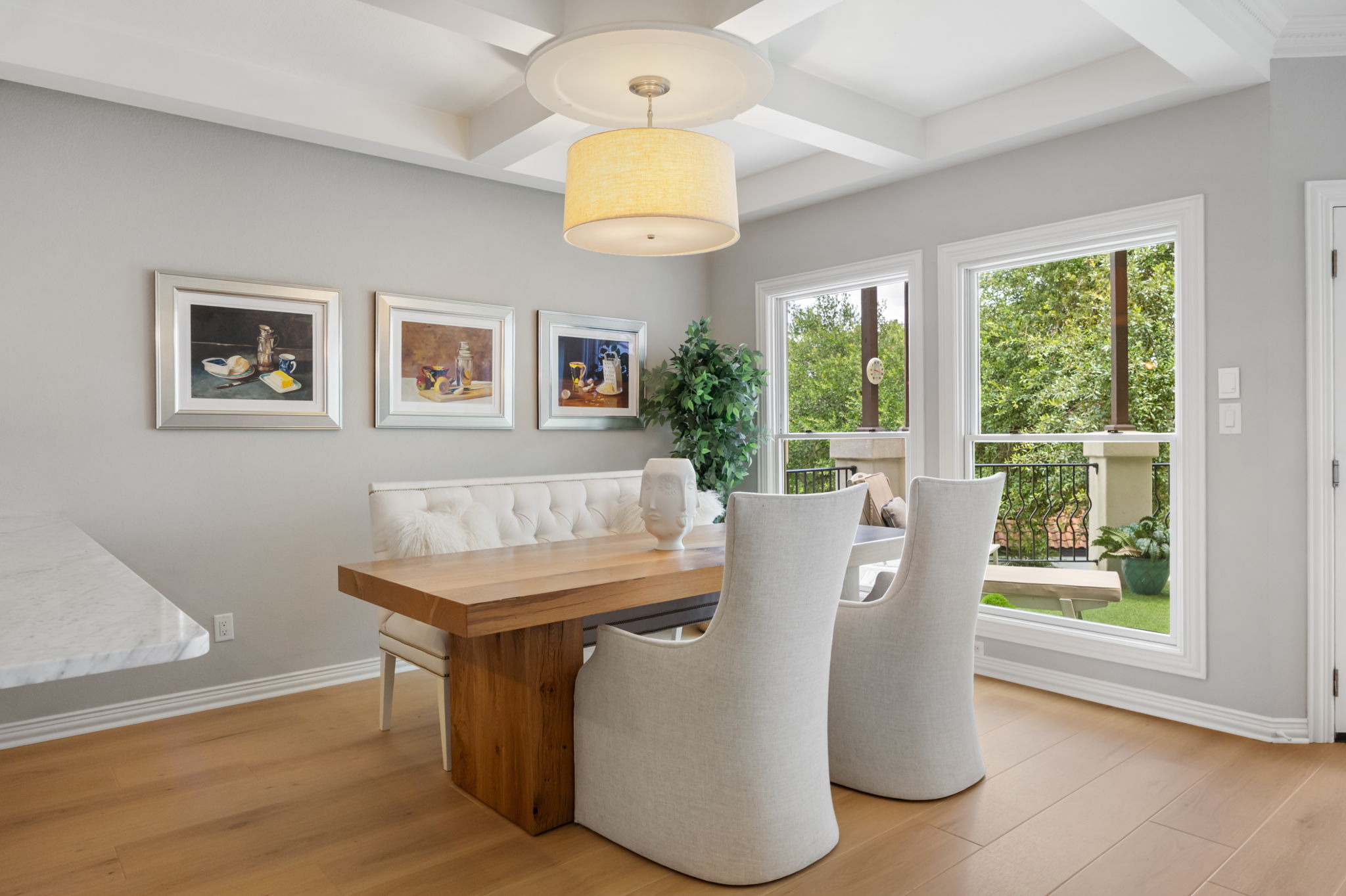 1910 Rue De St Tropez, Unit 6 Austin, TX 78746 - Photo 9 of 37 Hardwood flooring extends throughout this naturally illuminated dining space, featuring a coffered ceiling and expansive windows.