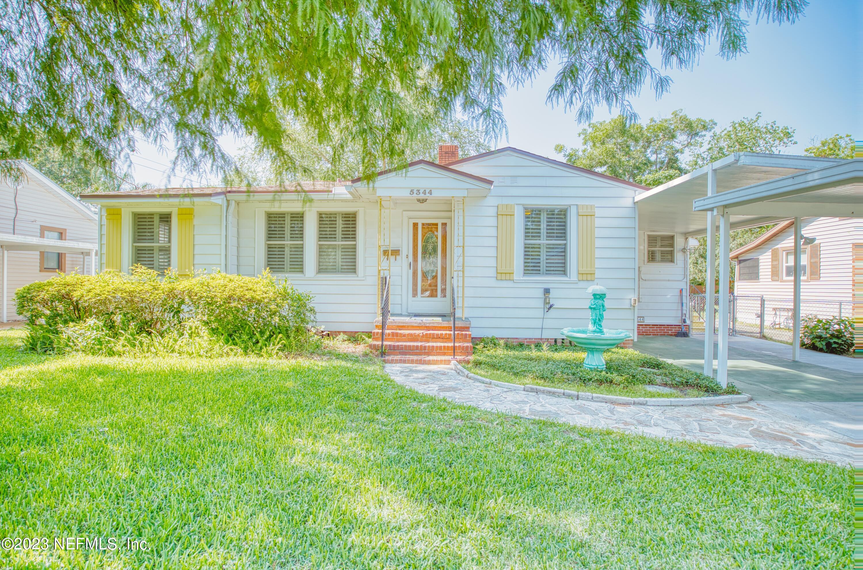 5344 Appleton Avenue Jacksonville, FL 32210 - Photo 1 of 44 a front view of a house with a yard table and chairs