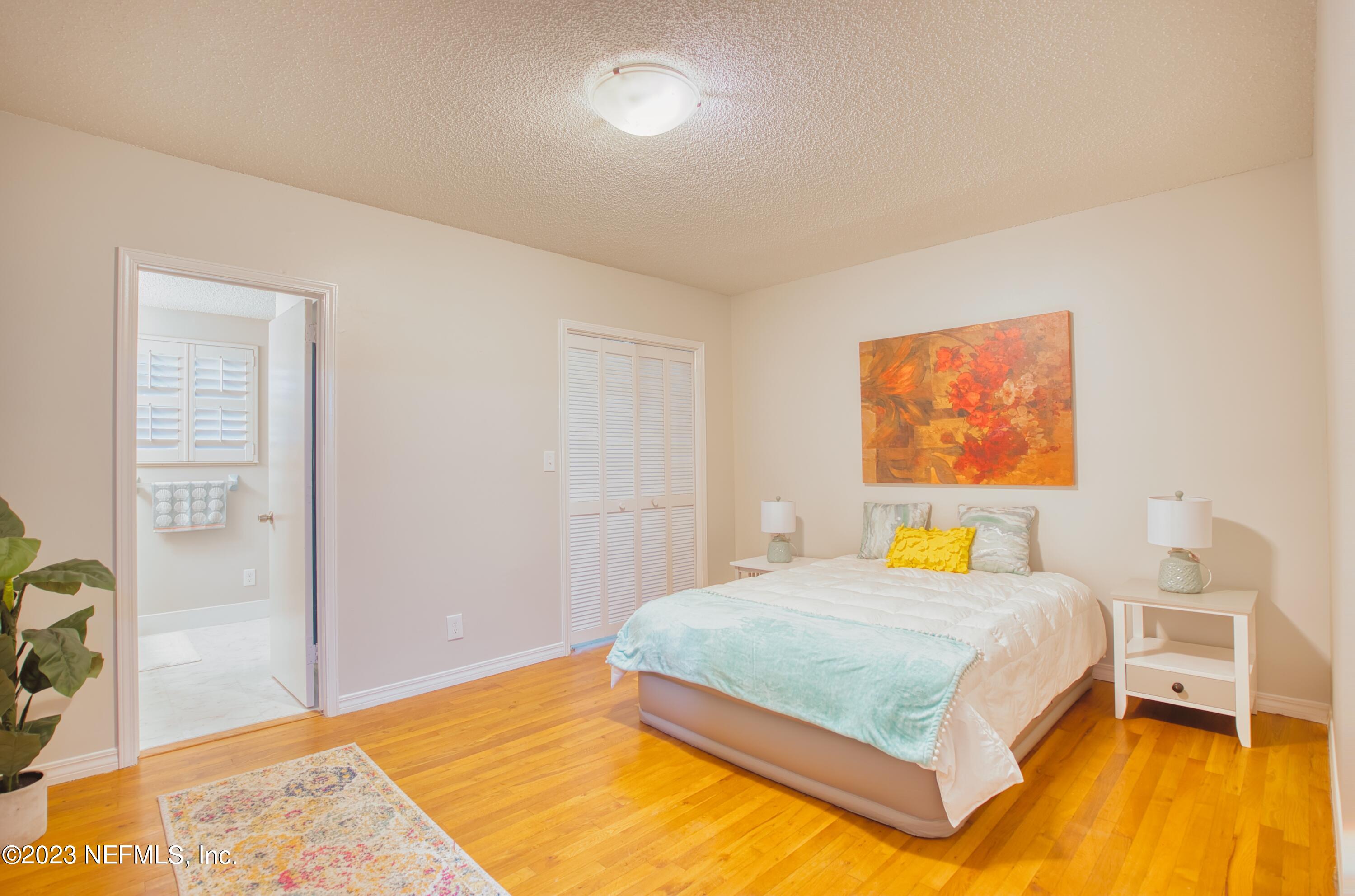5344 Appleton Avenue Jacksonville, FL 32210 - Photo 14 of 44 a bedroom with a bed and wooden floor