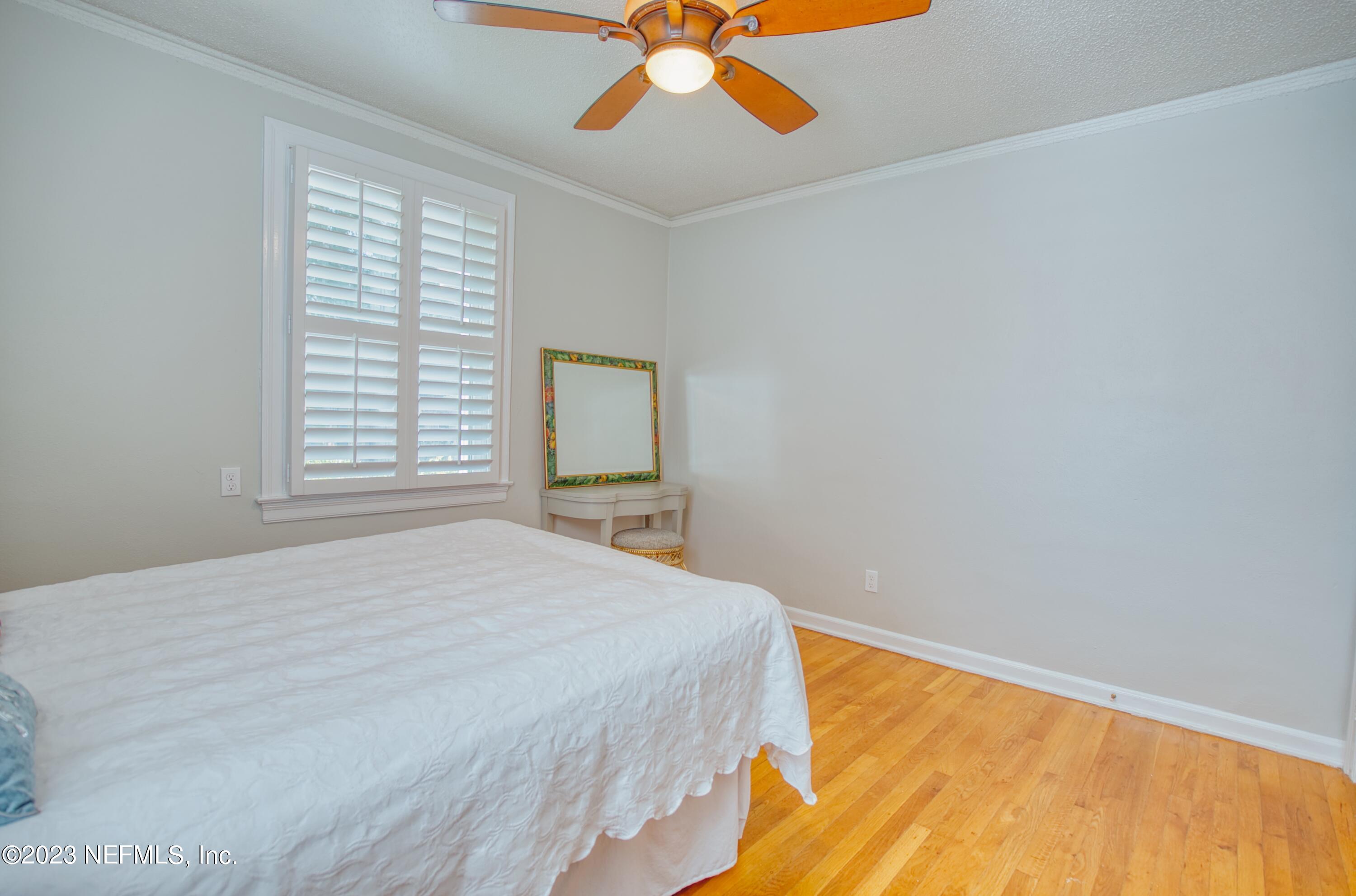 5344 Appleton Avenue Jacksonville, FL 32210 - Photo 23 of 44 a bedroom with a bed and a chandelier