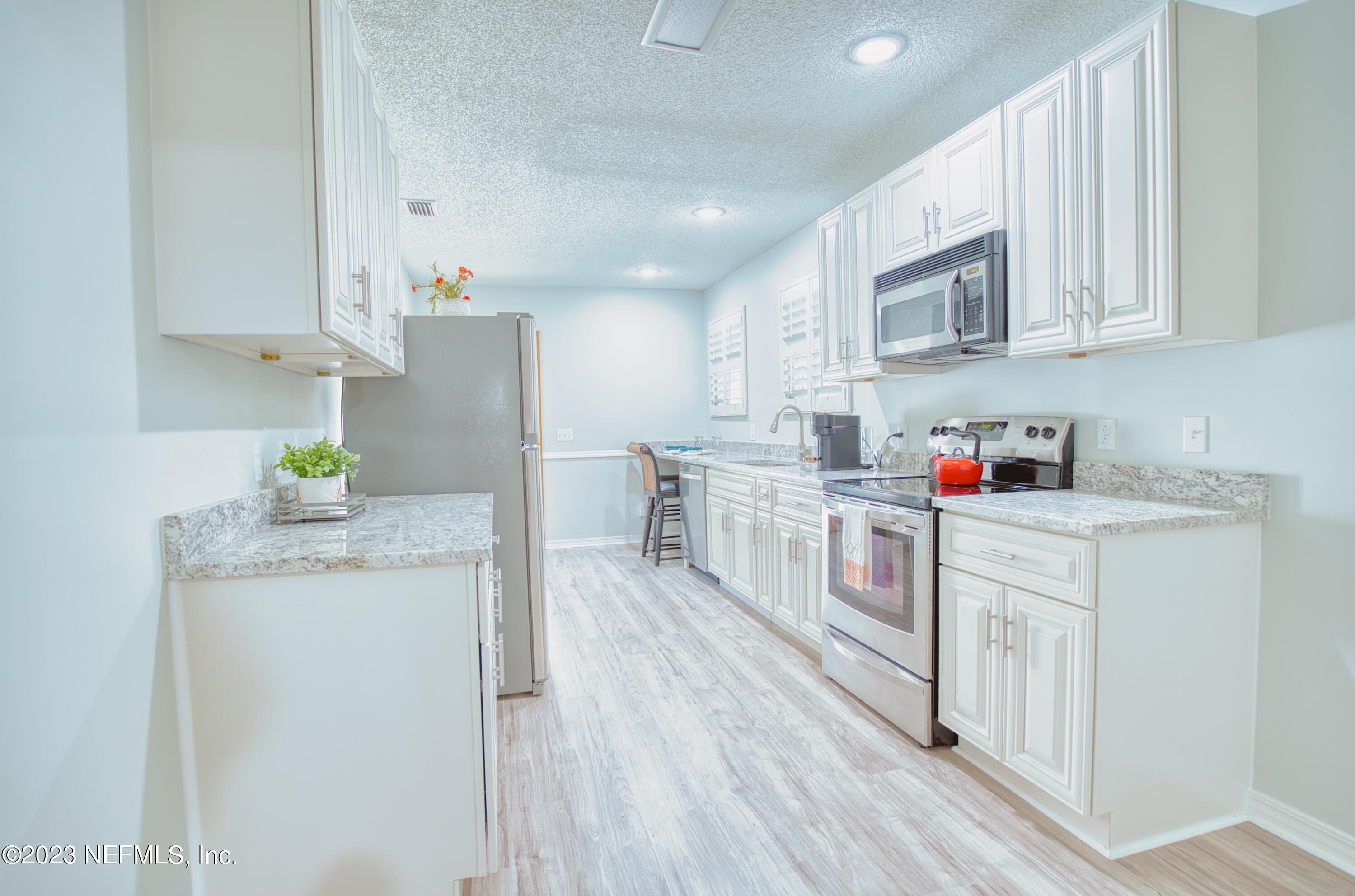 5344 Appleton Avenue Jacksonville, FL 32210 - Photo 9 of 44 a kitchen with white cabinets and white appliances