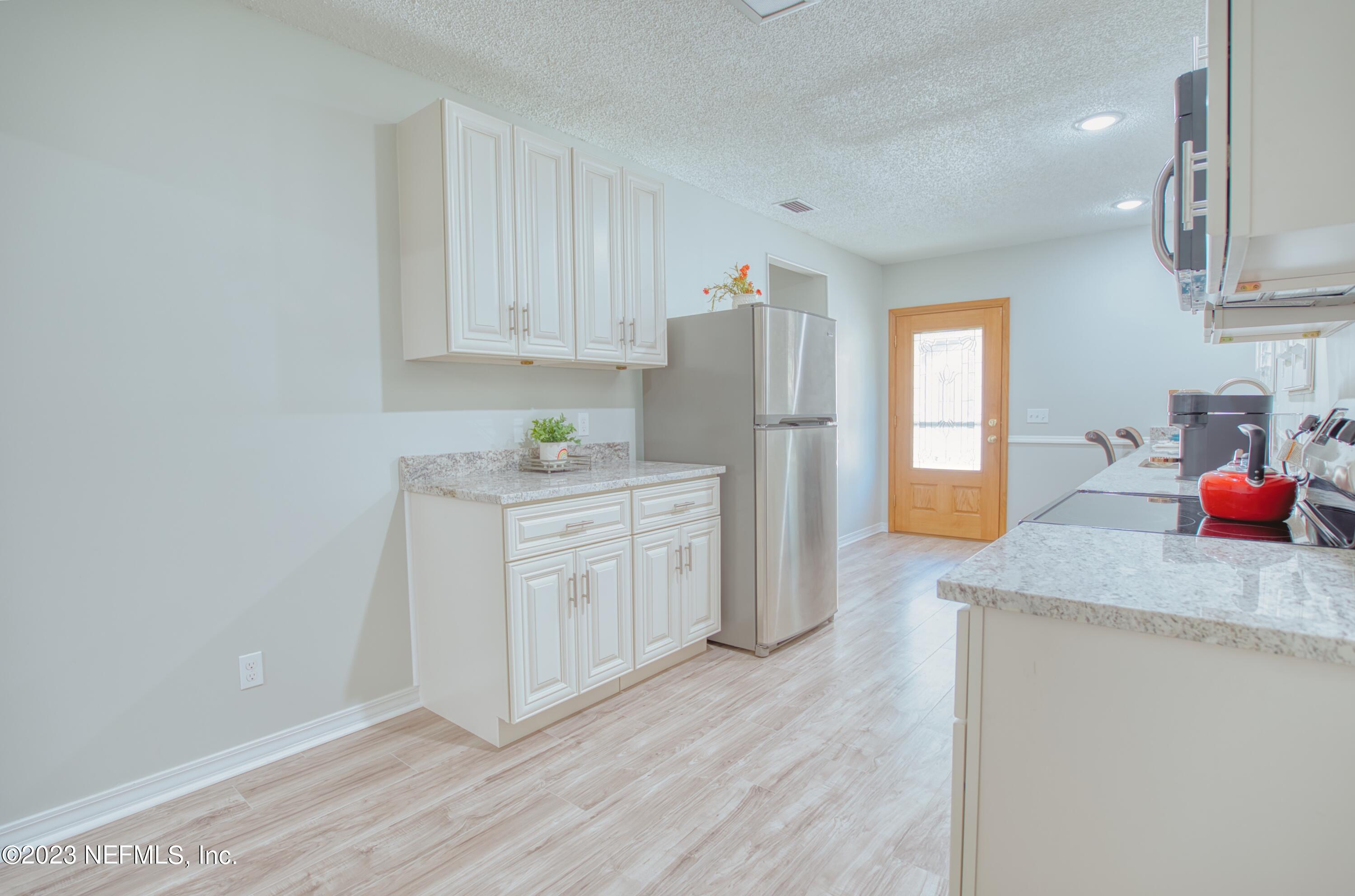 5344 Appleton Avenue Jacksonville, FL 32210 - Photo 10 of 44 a kitchen with stainless steel appliances granite countertop a refrigerator sink and white cabinets