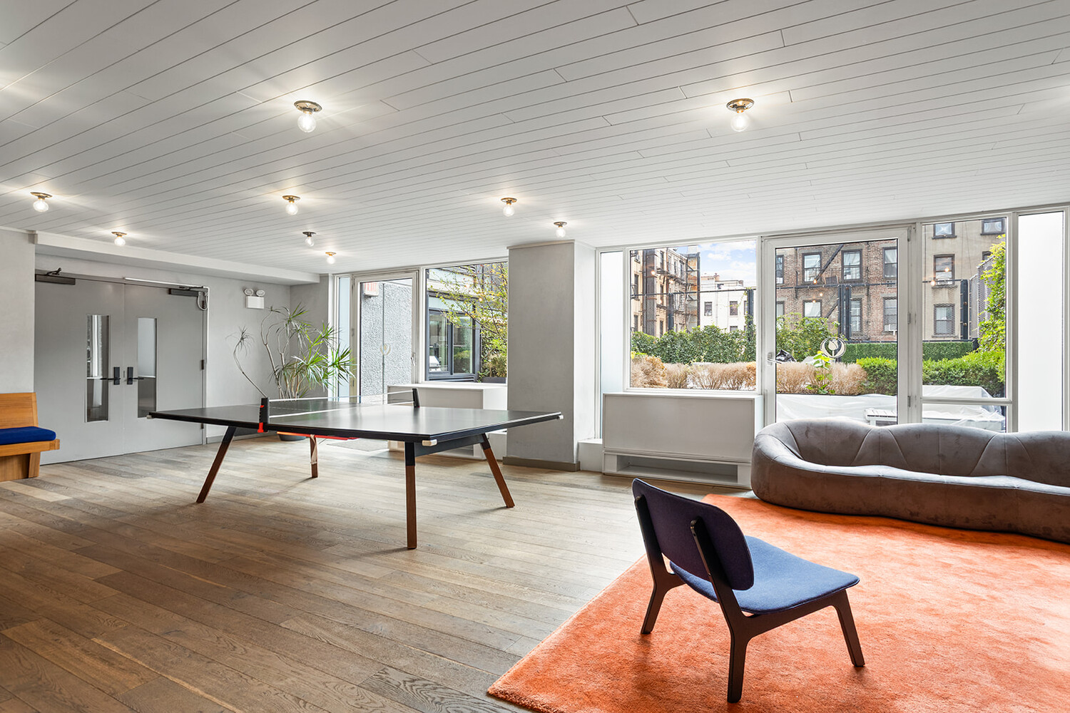 385 1st Avenue, Unit 7F Manhattan, NY 10010 - Photo 13 of 15 a living room with furniture and a wooden floor
