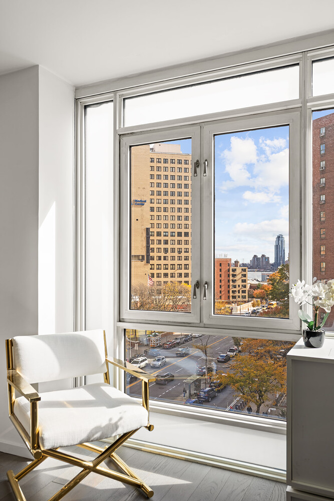 385 1st Avenue, Unit 7F Manhattan, NY 10010 - Photo 4 of 15 a living room with a large window and a floor to ceiling window