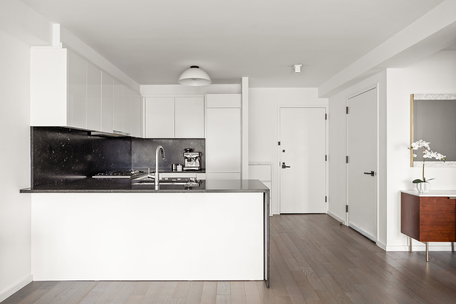 385 1st Avenue, Unit 7F Manhattan, NY 10010 - Photo 5 of 15 a kitchen with stainless steel appliances granite countertop a sink a microwave a refrigerator and white cabinets