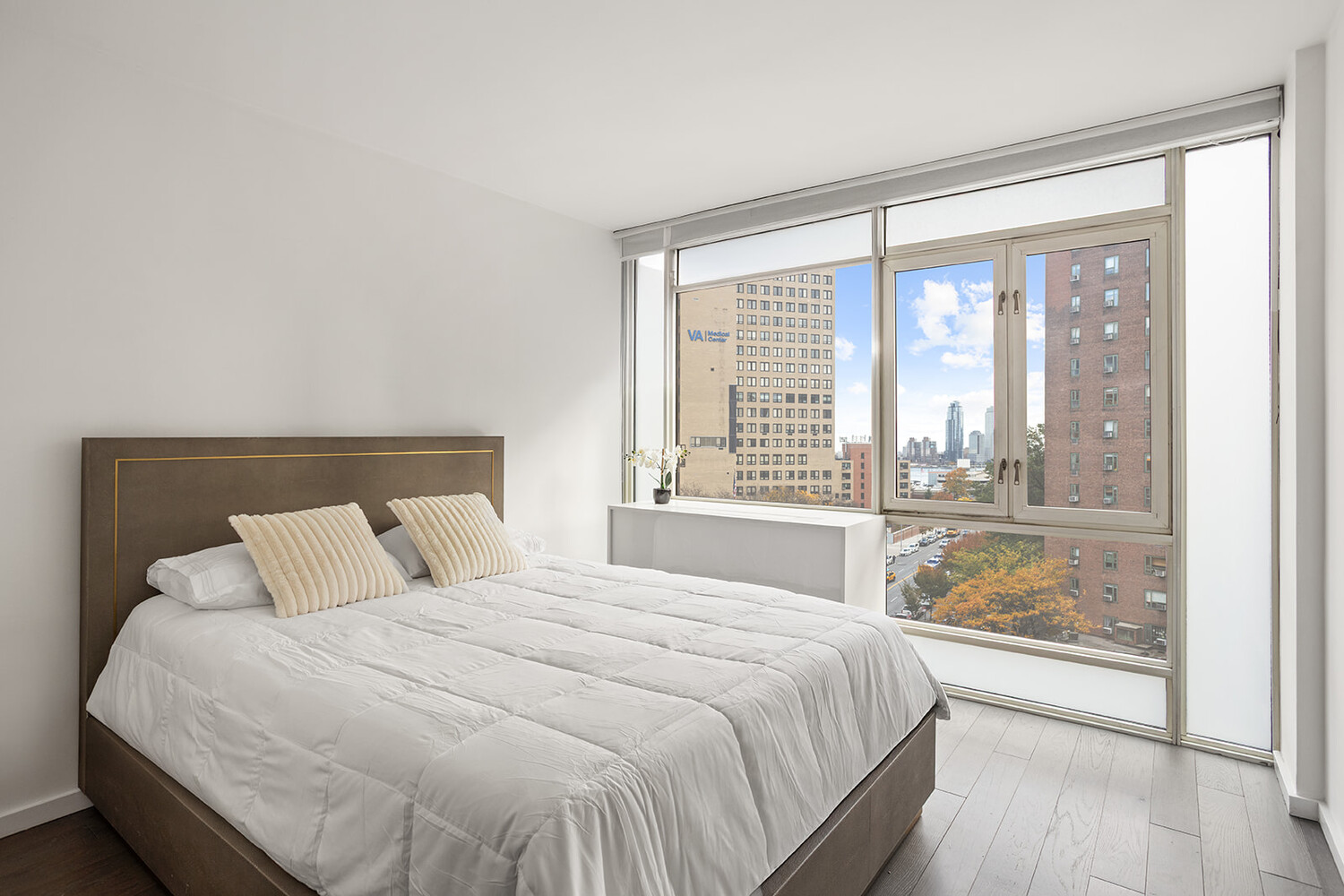 385 1st Avenue, Unit 7F Manhattan, NY 10010 - Photo 7 of 15 a bedroom with a large bed and a large window