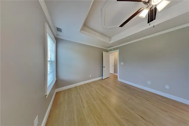 a view of an empty room with wooden floor