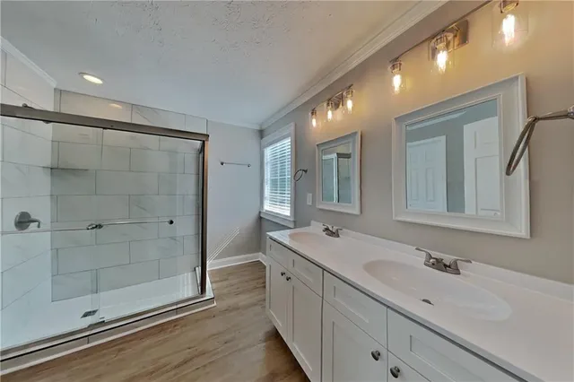 a spacious bathroom with a shower sink and mirror