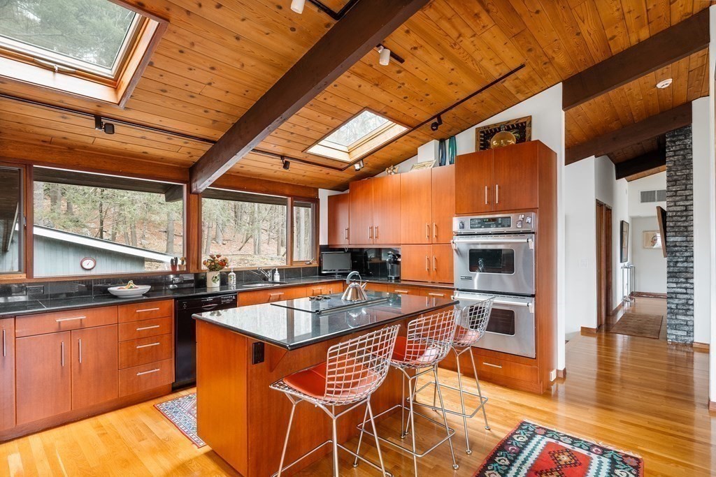 61 Scotch Pine Road Weston, MA 02493 - Photo 11 of 39 a kitchen with stainless steel appliances granite countertop a sink and wooden cabinets
