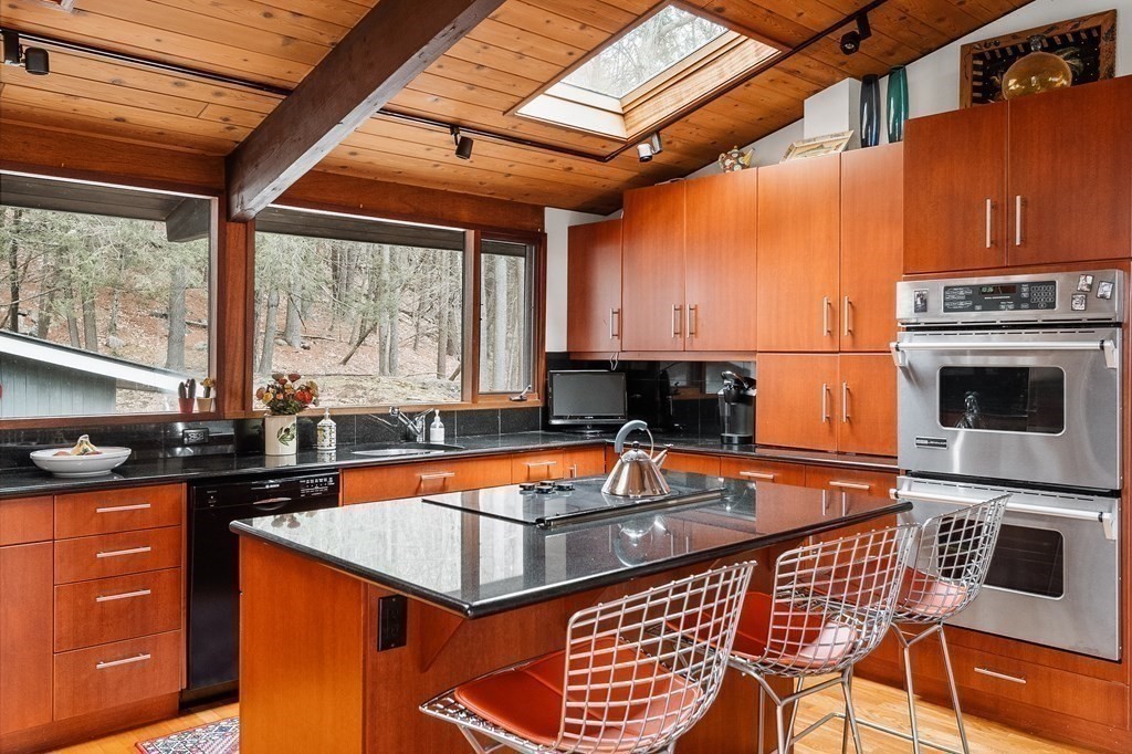 61 Scotch Pine Road Weston, MA 02493 - Photo 14 of 39 a kitchen with stainless steel appliances granite countertop a stove a sink and a microwave