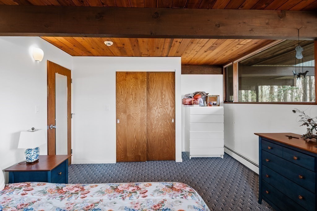 61 Scotch Pine Road Weston, MA 02493 - Photo 30 of 39 a bedroom with a bed and wooden floor