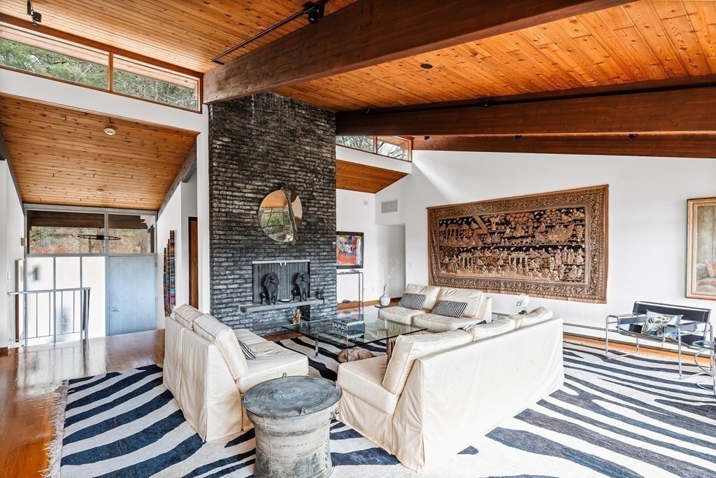 61 Scotch Pine Road Weston, MA 02493 - Photo 5 of 39 a living room with furniture a fireplace and a large window