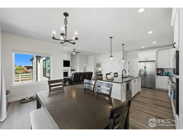 a living room with furniture and kitchen view