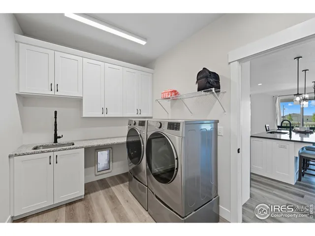 a utility room with cabinets washer and dryer