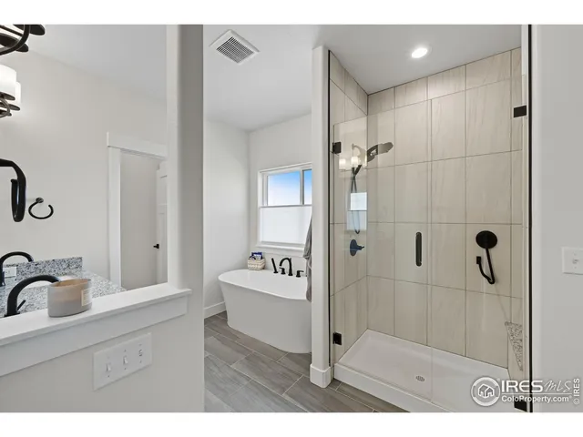 a bathroom with a sink a mirror and shower