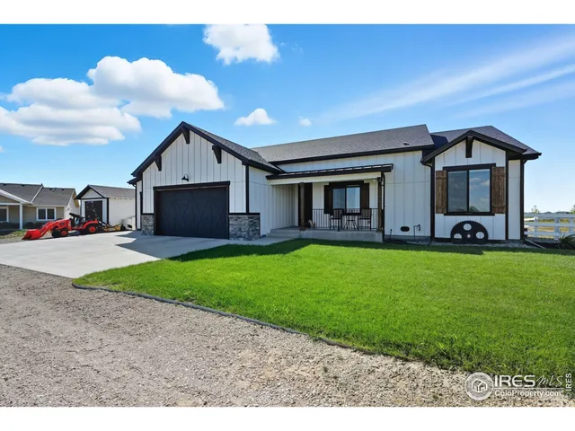 a front view of a house with a garden and yard