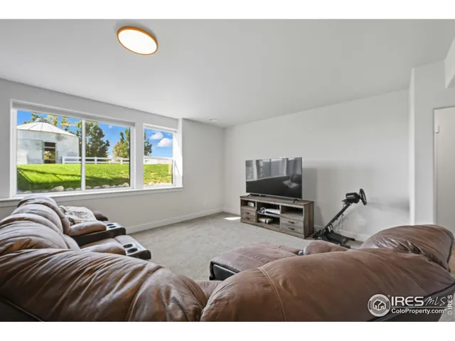 a bedroom with a bed and a tv