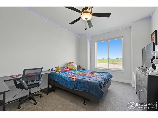 a bedroom with a bed a desk and chair