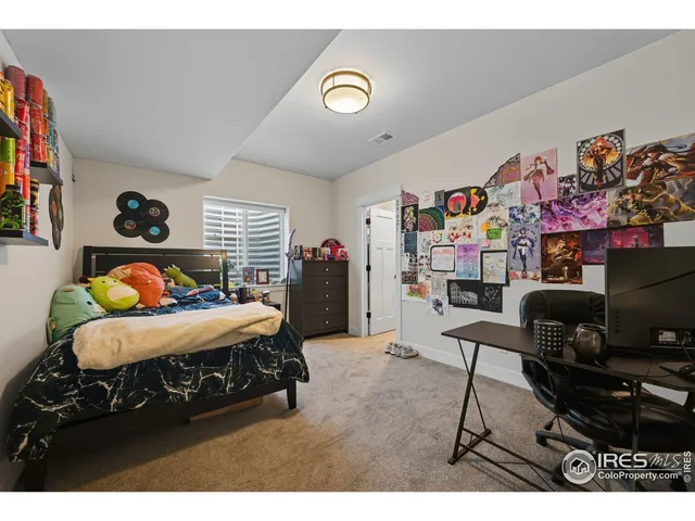 a bedroom with a bed and a desk