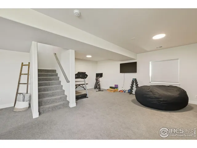 a living room with furniture and stairs