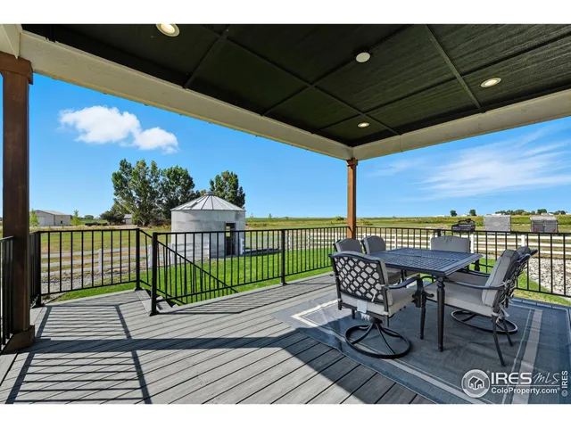 a view of a roof deck with furniture