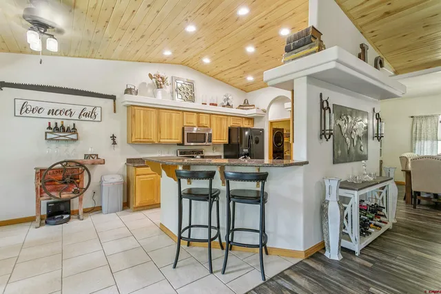 a kitchen with stainless steel appliances kitchen island granite countertop a sink and cabinets