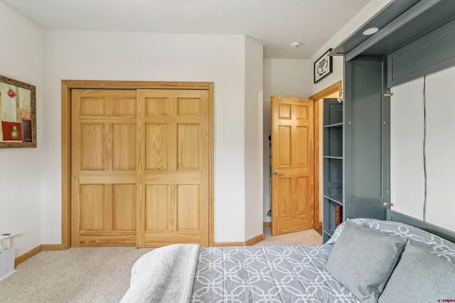 a bedroom with a bed and a cabinet
