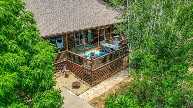 a view of backyard with outdoor seating and trees