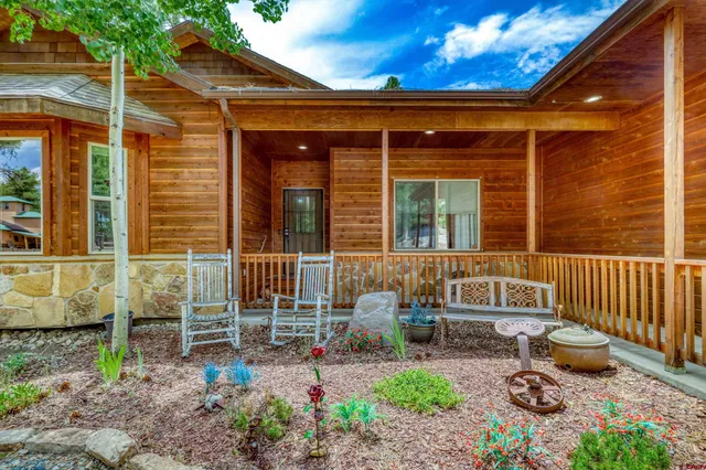 a view of a chair and table in backyard of the house