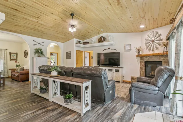 a living room with furniture flat screen tv and a fireplace