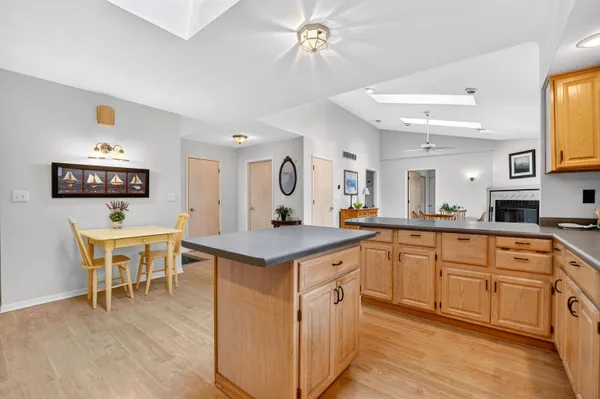 a kitchen with a sink cabinets and dining table chair