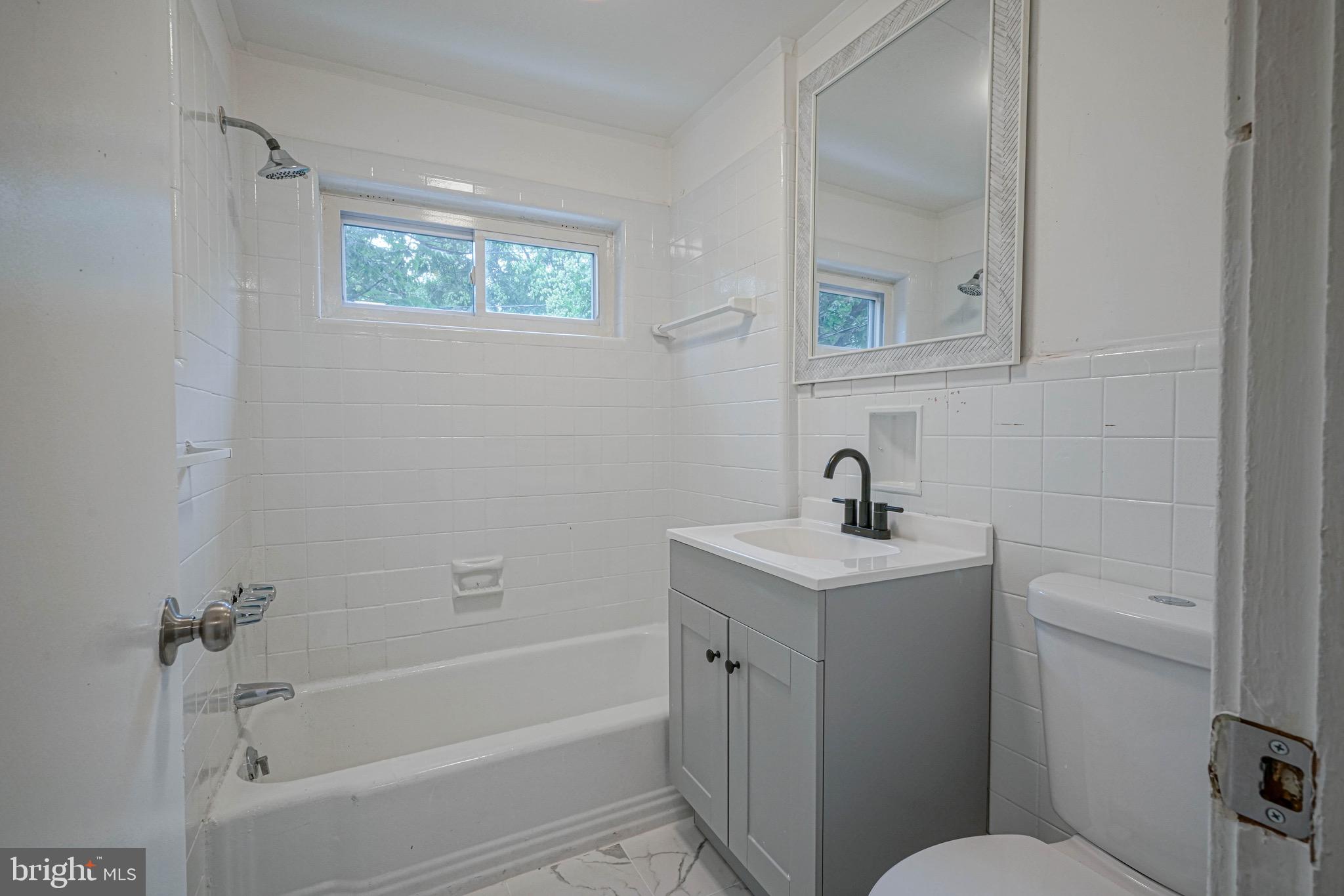 1662 Minnesota Road Camden, NJ 08104 - Photo 16 of 22 a bathroom with a sink a toilet and shower