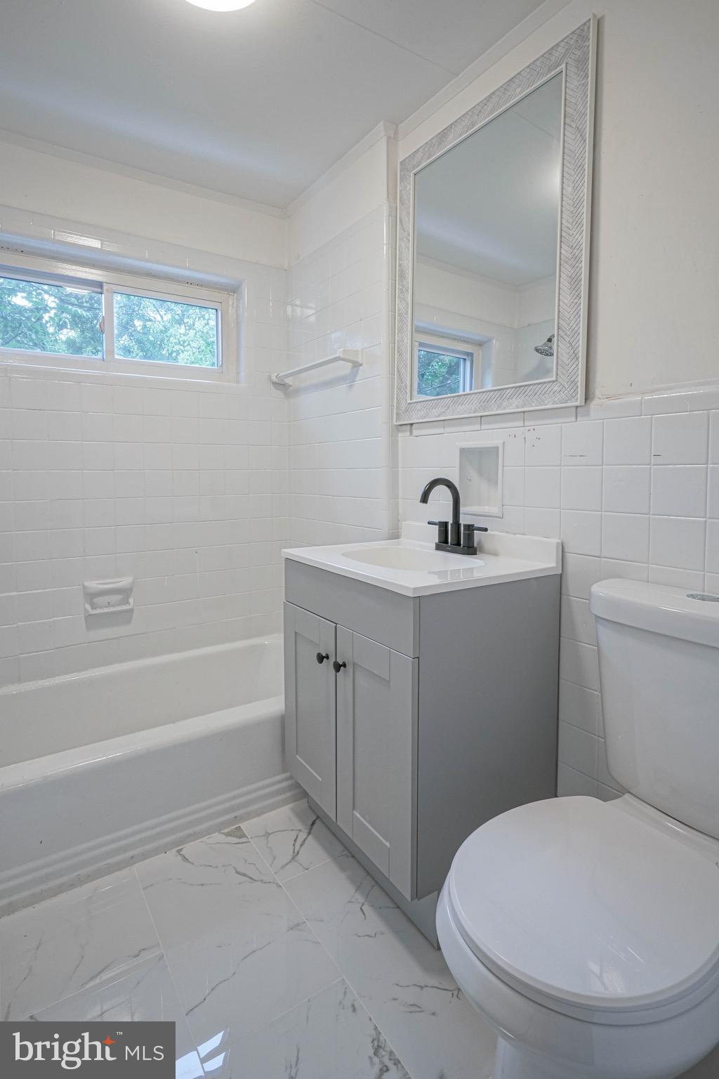 1662 Minnesota Road Camden, NJ 08104 - Photo 17 of 22 a bathroom with a toilet a sink and mirror
