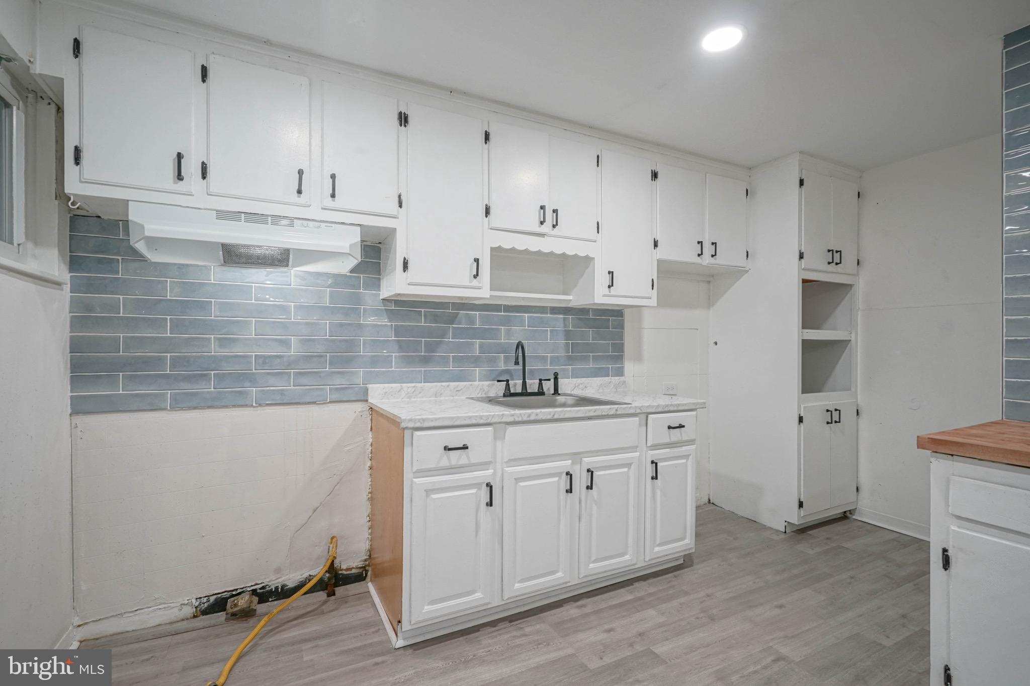 1662 Minnesota Road Camden, NJ 08104 - Photo 8 of 22 a kitchen with a sink stove and cabinets