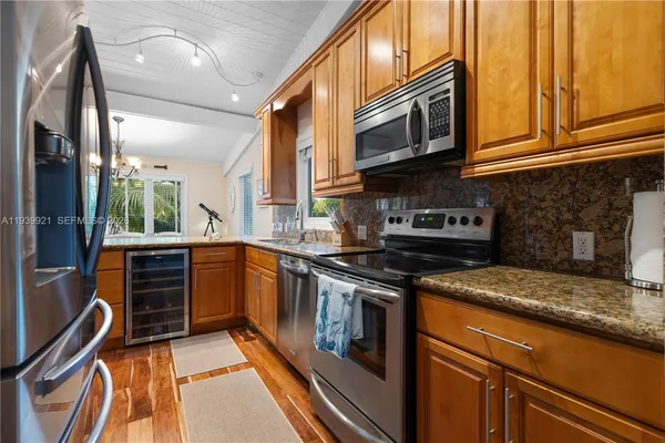 a kitchen with stainless steel appliances granite countertop a stove and a sink