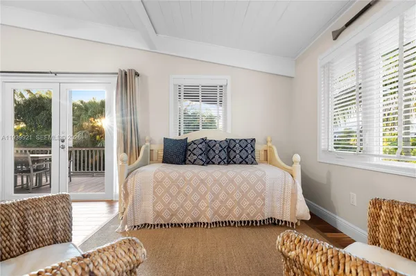 a bedroom with a bed and glass window