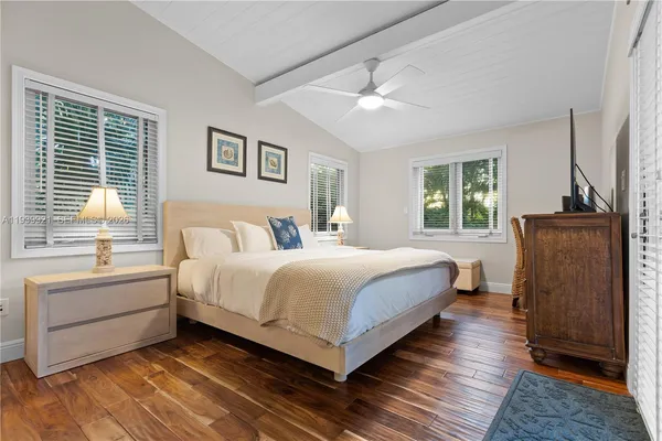 a bedroom with a bed and a television