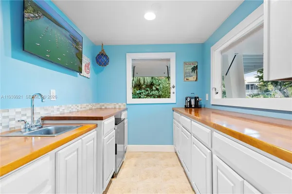 a view of a kitchen with a sink and a large window