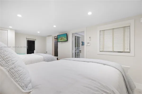 a bedroom with a large bed and a large window